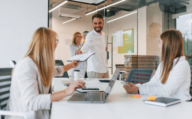 istock Taking the documents. Group of professional business people is in the office 1419062059