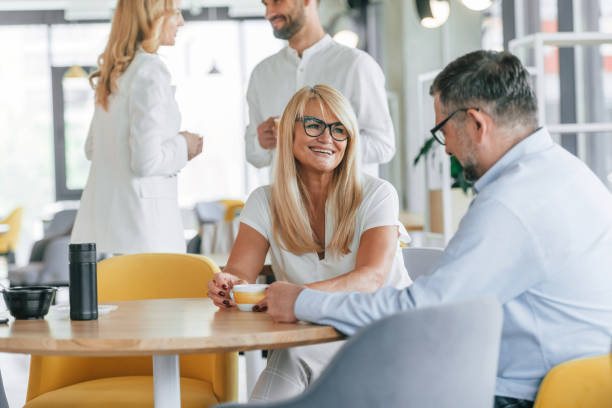 istock Break time with drinks. Group of professional business people is in the office 1419062152