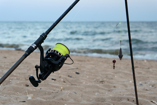 Fishing tackle on the sea shore. Vacation and hobby concept.