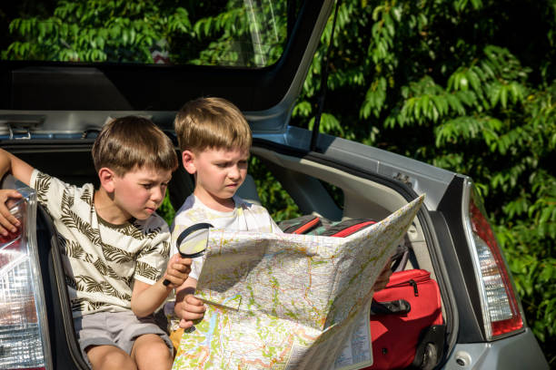 istock Two cute boys sitting in a car trunk before going on vacations w 1419064556