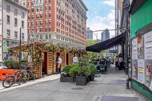 Manhattan, New York, NY, USA - July 9th 2022: During the Covid-19 situation a lot of open air restaurants and sidewalk cafes where established on Manhattan, this one in the famous 5th Avenue just north of Madison Square Park