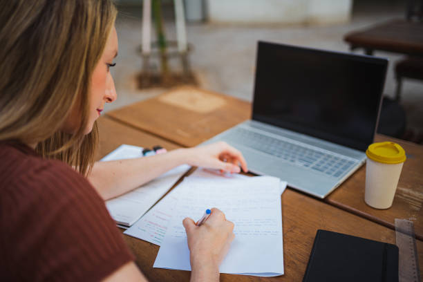 istock Perspective shot of student girl taking notes 1419065529