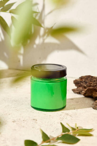 istock Green empty jar for cosmetics. Mockup for natural cosmetics. Nature composition with aromatic candle in jar. Mockup soy wax candle in natural style. Empty jar  with cosmetic product for design. 1419065819