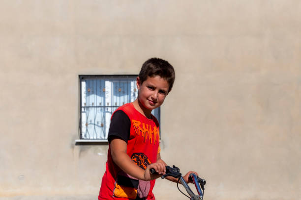 Boy tourist boy eating turkish ice cream while exploring valley with rock formations and fairy caves near Goreme in Cappadocia Turkey.