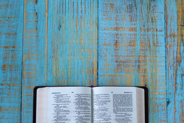 istock Open Holy Bible Book on a blue rustic wooden background with copy space 1419068144