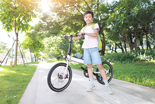 Boy riding bike in city park