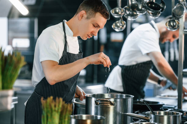 istock Professional employees. Kitchen workers is together preparing the food 1419073159