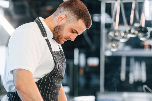 istock Focused on work. Chef is on the kitchen preparing food 1419073253