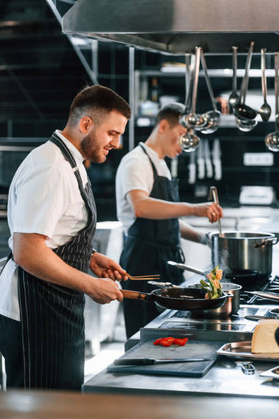 istock In uniform. Kitchen workers is together preparing the food 1419073944