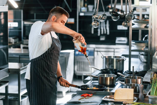 istock Focused on work. Chef is on the kitchen preparing food 1419073959