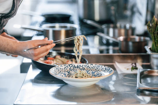 istock Busy at work. Chef is on the kitchen preparing food 1419074318