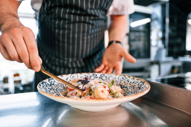 istock Making salad. Chef is on the kitchen preparing food 1419076600