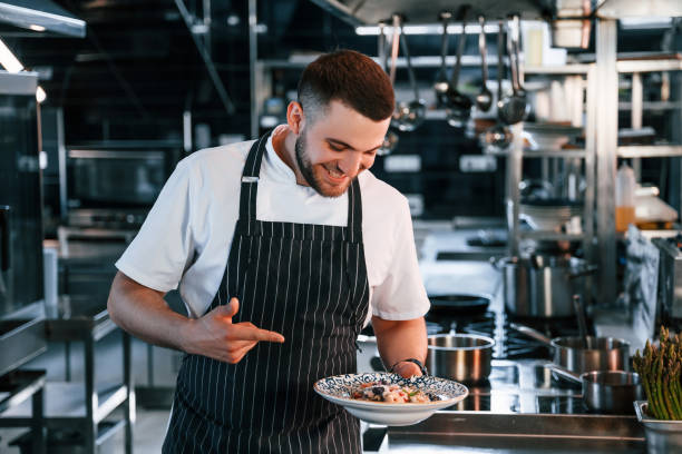 istock Making salad. Chef is on the kitchen preparing food 1419076603