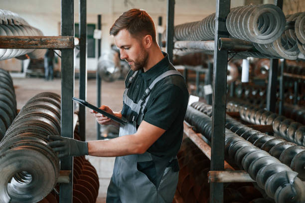 istock Checking details. Man in uniform is in workstation developing details of agriculture technique 1419076998