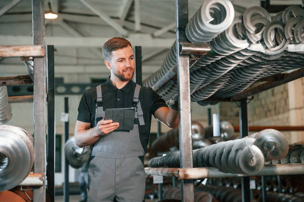 istock Holding tablet. Man in uniform is in workstation developing details of agriculture technique 1419077033