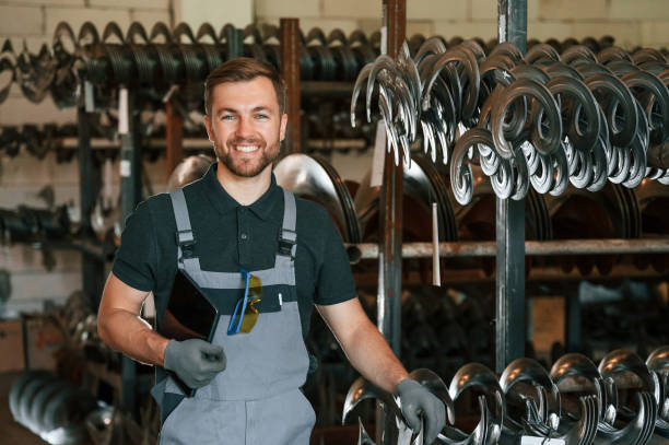 istock Grey uniform. Man is in workstation developing details of agriculture technique 1419077284
