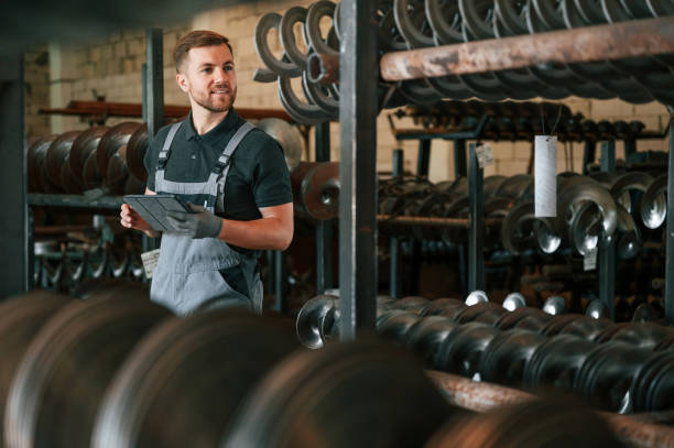 istock Checking quality of the products. Man in uniform is in workstation developing details of agriculture technique 1419077382