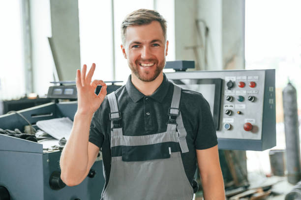 istock Standing near operate device. Man in uniform is in workstation developing details of agriculture technique 1419077583