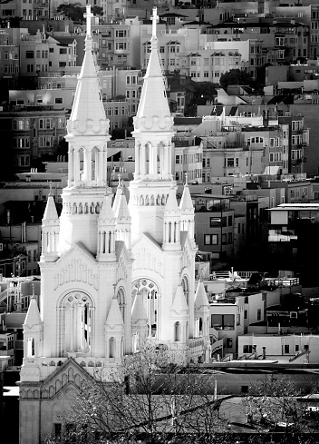 St Peter and Paul Church in San Francisco with city buildings and homes in background