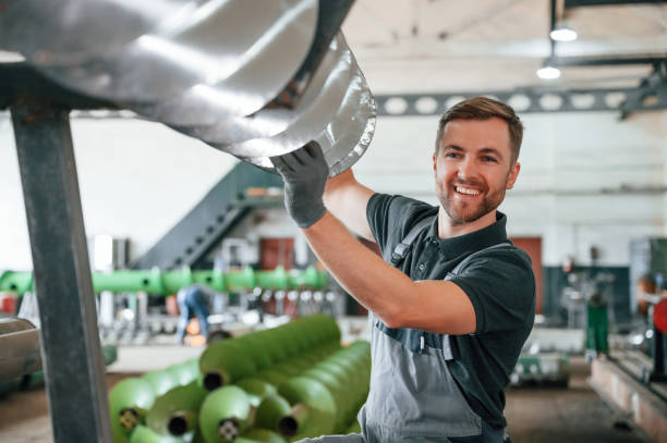 istock Sharp edges of equipment. Man in uniform is in workstation developing details of agriculture technique 1419078037