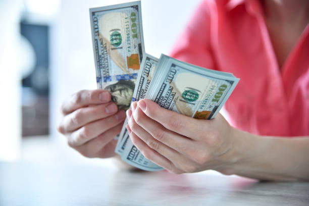 Trader woman hands counting US dollars cash in office Trader woman hands counting US dollars cash in office. Financial success and business concept. Close up devaluation stock pictures, royalty-free photos & images