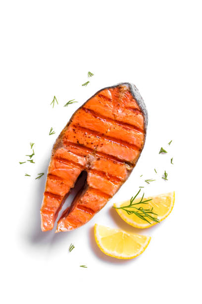 Grilled salmon fish steak Grilled salmon fish steak isolated on white background. Roasted salmon piece - healthy food ingredient. sockeye salmon filet stock pictures, royalty-free photos & images