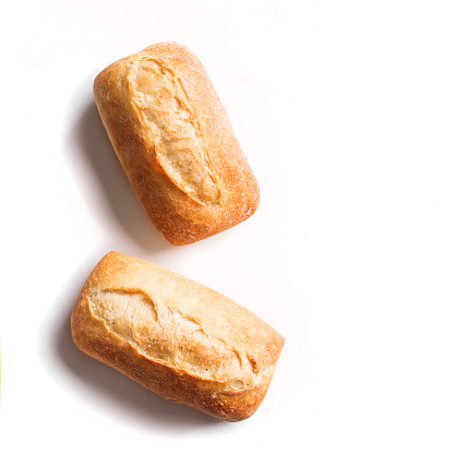 Fresh homebaked artisan bread. Two mini baguette bread isolated on white background, design element.