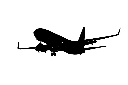 Black silhouette of a flying airplane on a white background