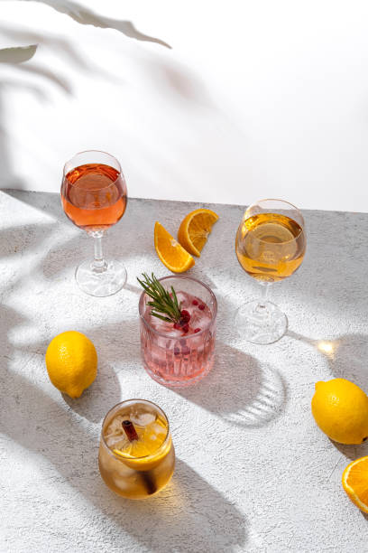 istock Sparkling holiday punch and various drinks. Glasses of sparkling punch on light background. Cocktail with orange, Ice and cinnamon. Refreshing Summer Drink. Free space for your text 1419083710
