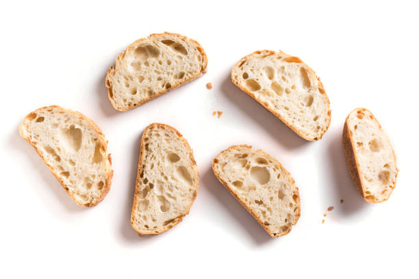 Slices of fresh bread Fresh homebaked artisan sourdough bread. Slices of bread isolated on white background, design element. baguette stock pictures, royalty-free photos & images