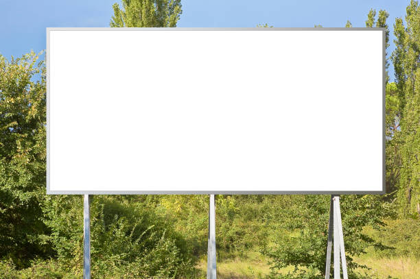istock Blank advertising signboard with trees on background - concept with copy space for text inserting 1419084033