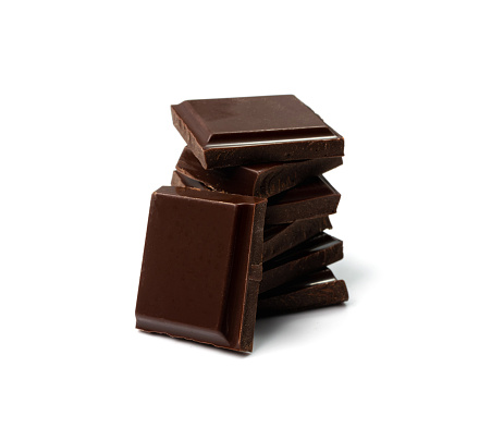 Broken chocolate bar stack, isolated. Milk chocolate square pieces, cubes, small bloks pile, choco segments on white background side view