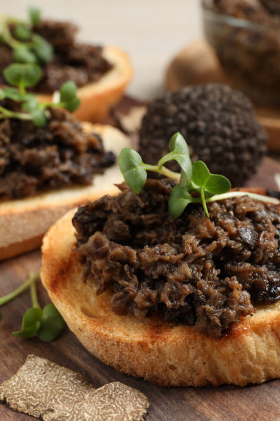istock Delicious bruschettas with truffle sauce and microgreens on wooden table, closeup 1419088465