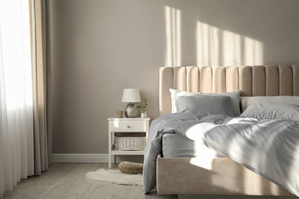 istock Bed with stylish silky linens in room 1419089253