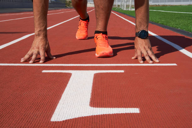 istock Hands on the starting line, the sprinter is preparing to start at the stadium. 1419089288