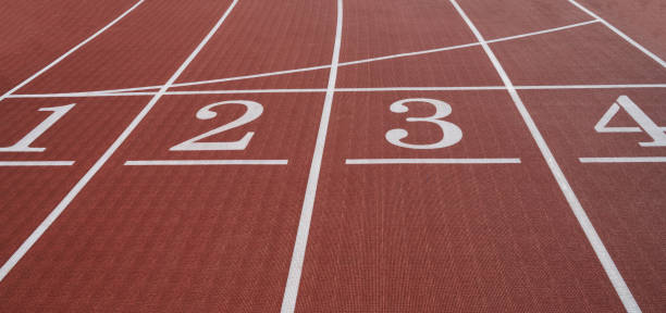 istock Running track. Red treadmill at the stadium with white lines. 1419090158
