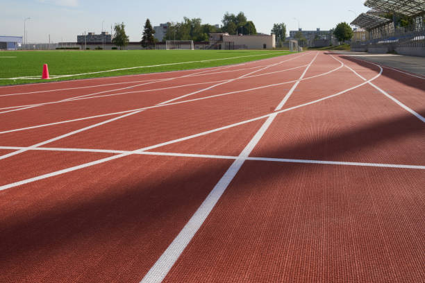 istock Running track. Red treadmill at the stadium with white lines. 1419090170