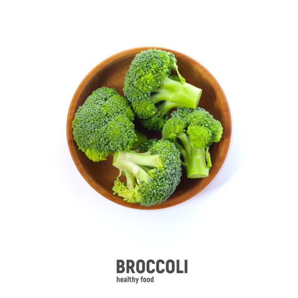 istock Broccoli in wooden bowl, isolated on white background, top view. 1419090864