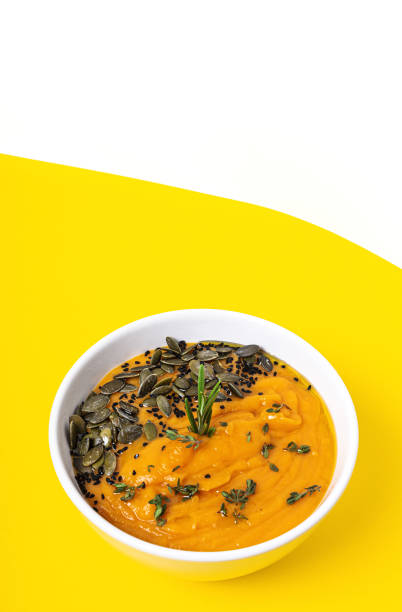 Homemade pumpkin cream soup bowl background