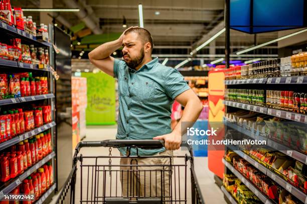 Man Feeling Upset About The Increase In Food Prices Stock Photo - Download Image Now