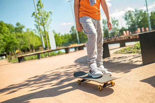 Asian woman skateboarder skateboarding in modern city