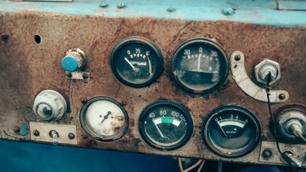 Photo of The rusty steel dashboard of a very old tractor close-up