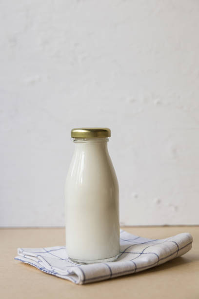 istock Ayran in a glass bottle on a light background 1419092960