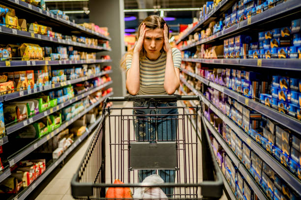 Woman feeling worried about the increase in food prices stock photo
