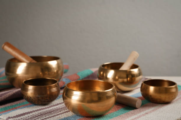 istock Tibetan singing bowls with mallets on colorful fabric, space for text 1419094511