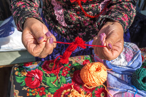 istock A woman needlewoman makes ancient Slavic dolls amulets from threads 1419095962