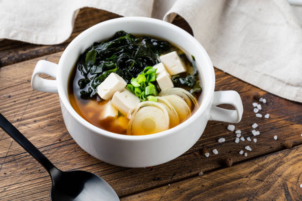 Japanese miso soup in a white bowl on the table. Horizontal view from above stock photo