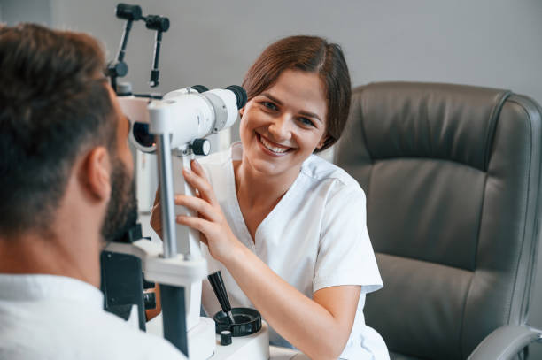 istock Modern technologies. Man's vision checked by female doctor in the clinic by using special optometrist device 1419096344