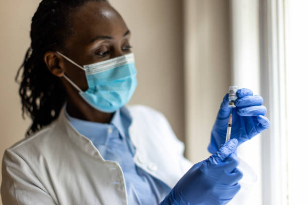 istock Black nurse preparing COVID-19 vaccine 1419096508