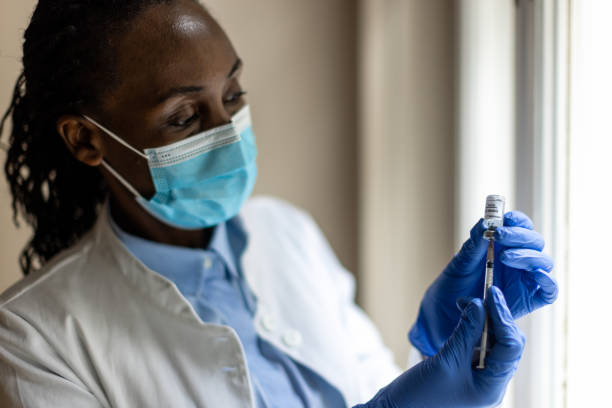 istock Black nurse preparing COVID-19 vaccine 1419096672